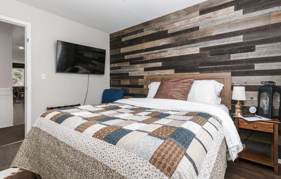 The Virginian western queen room with reclaimed wood wall at LibraryInn, Lava Hot Springs Idaho